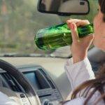 woman drinking with child in car blog